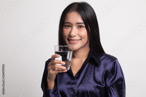 Young Asian woman with a glass of drinking water.