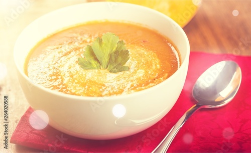 Tasty Pumpkin or carrot soup on background