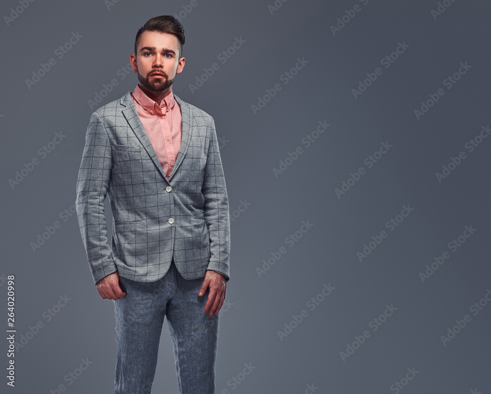 Portrait of styilish serious man in checkered blazer and pink shirt. 