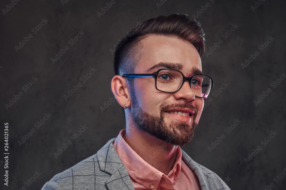 Portrait of young smiling man in checkered blazer, pink shirt and glasses Portrait of young smiling man in checkered blazer, pink shirt and glasses