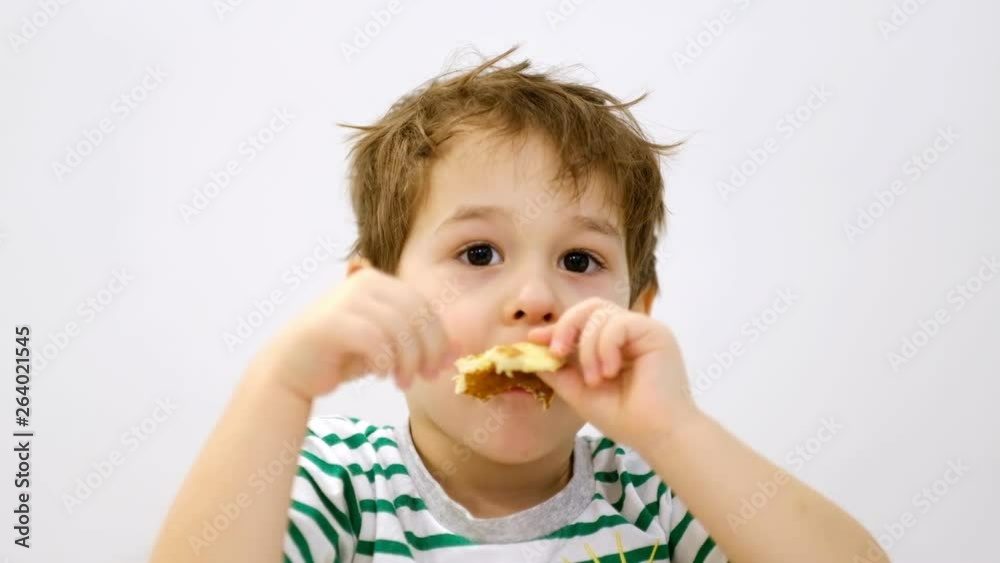 Little boy funny eats a thin pancake. Breakfast Little boy funny eats a thin pancake. Breakfast
