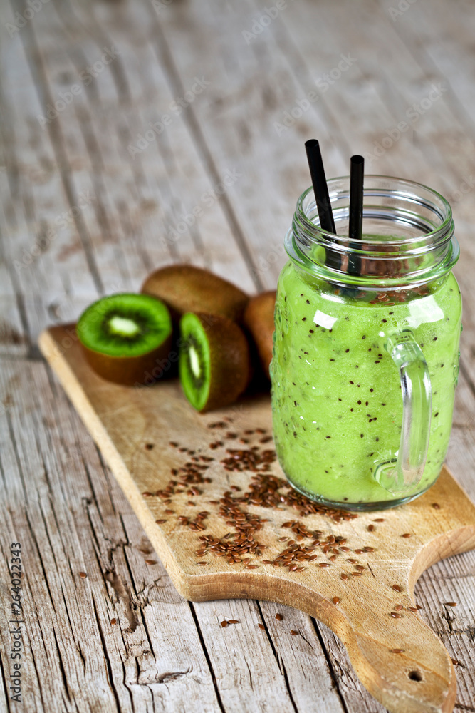 Green smoothie with kiwi, apple, lemon and linen seeds. Healthy fresh diet eating, superfood. Green smoothie with kiwi, apple, lemon and linen seeds. Healthy fresh diet eating, superfood.