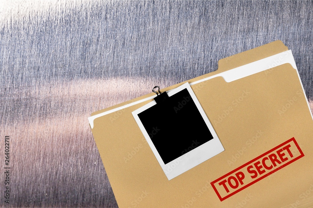 Φωτογραφία A manila folder with the faded words Top Secret on the front, isolated on  backg