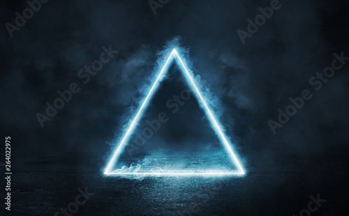 Empty background scene. Dark street reflection on the wet pavement. Rays of blue neon light in the dark, neon figures, smoke. Night view of the street, the city. Abstract dark background.