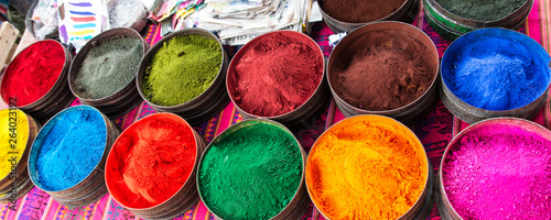Various coloful Peruvian dyes in powder form in tins