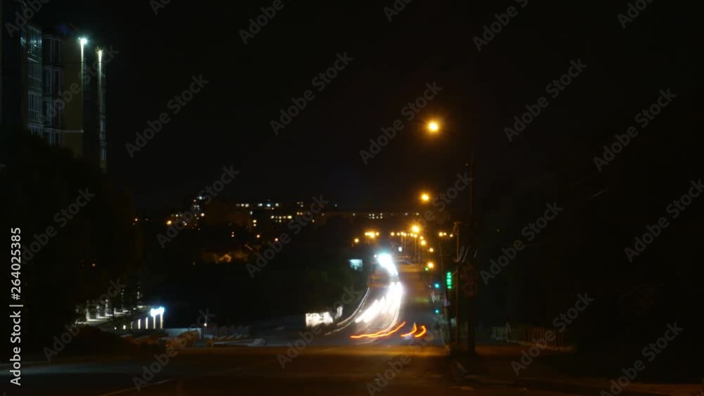Time lapse of driving a car in the city at night time. Hyper laps in the evening downtown