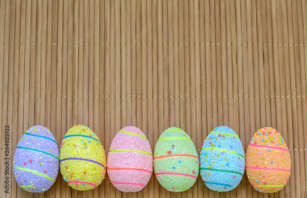 Handmade Easter eggs on a wooden background with space for text.