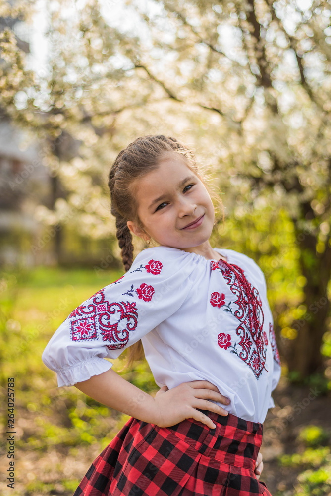 beautiful girl in traditional embroidered shirt jacket in the garden. Ukraine beautiful girl in traditional embroidered shirt jacket in the garden. Ukraine