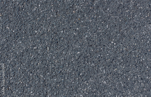 Black grainy asphalt with gravel texture background