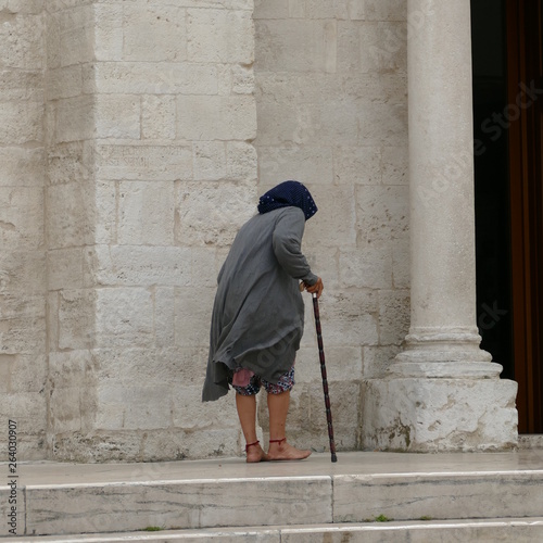 Anziana signora mendicante scalza  photo