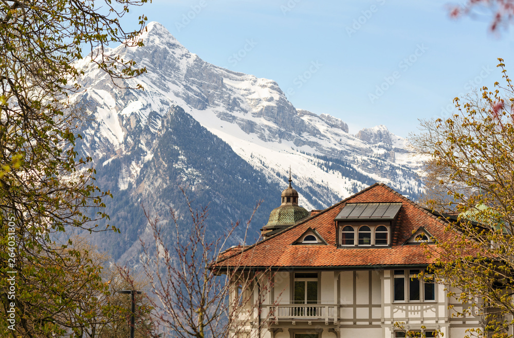 Beautiful old house on the background of the Alps. Weesen, Switzerland.