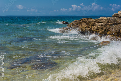Fototapeta Naklejka Na Ścianę i Meble -  Waves breaking on a stony beach in Murter, Croatia, Dalmatia