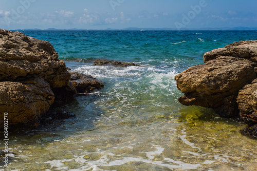 Fototapeta Naklejka Na Ścianę i Meble -  Waves breaking on a stony beach in Murter, Croatia, Dalmatia