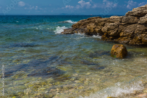 Fototapeta Naklejka Na Ścianę i Meble -  Waves breaking on a stony beach in Murter, Croatia, Dalmatia