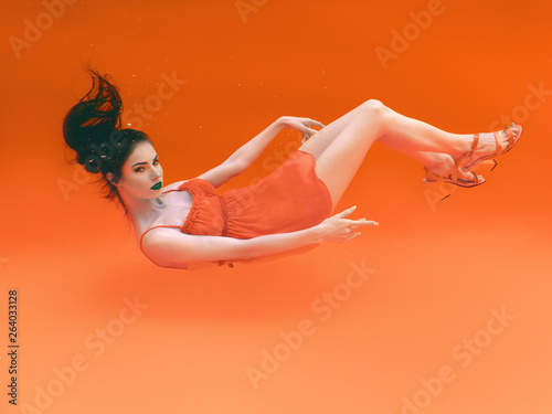 portrait of surreal, concept, art, orange, abstract, futuristic ultraviolet beautiful young woman underwater in negative style