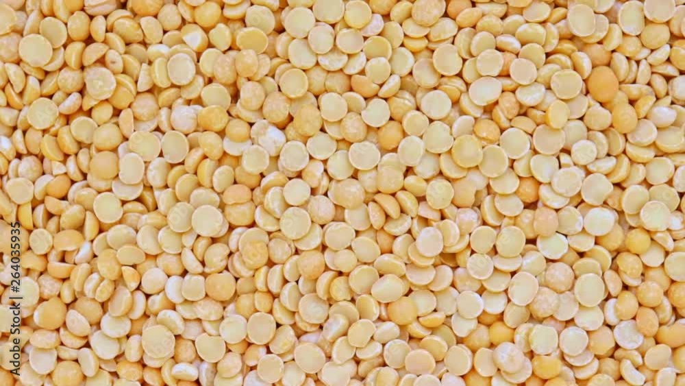 Dry yellow split peas rotation background texture, vegetable protein source fo vegetarians and vegans Dry yellow split peas rotation background texture, vegetable protein source fo vegetarians and vegans