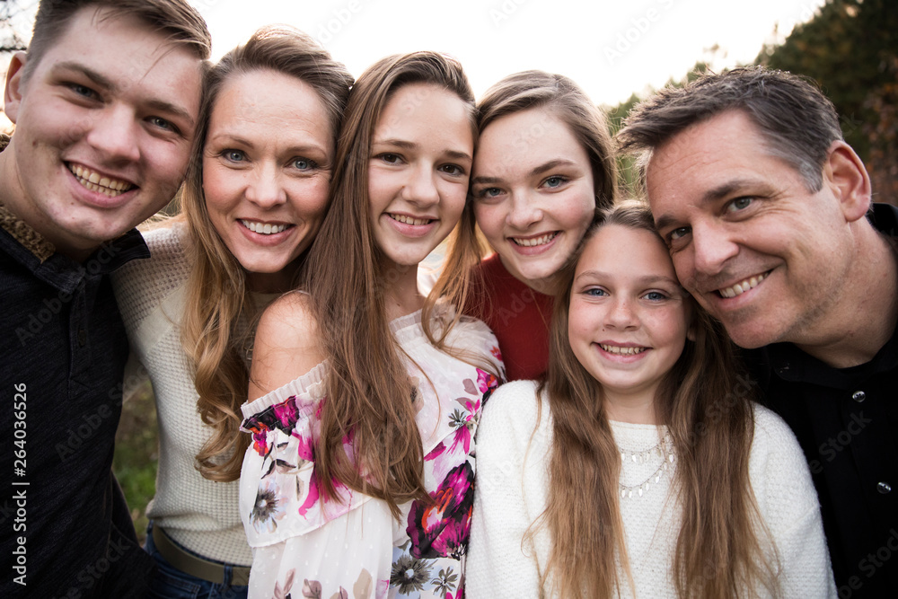 Close View of Faces of Happy Smiling Large Family of Teenagers Close View of Faces of Happy Smiling Large Family of Teenagers