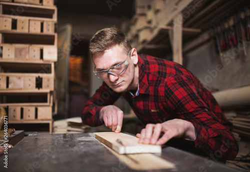Professional male carpenter working in workshop