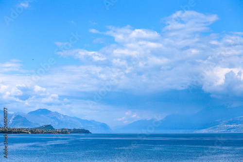 lake in the mountains with blue clouds and high rocks 