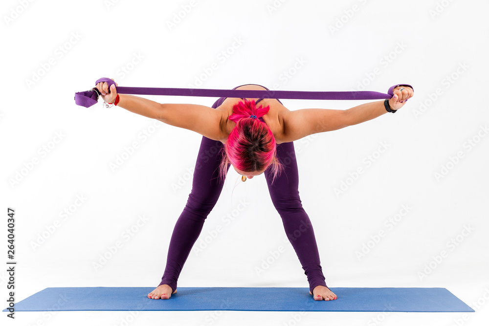 Girl doing yoga with elastic band on white background