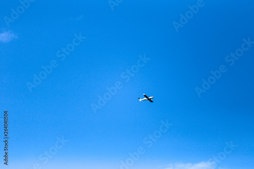 small plane in blue sky 