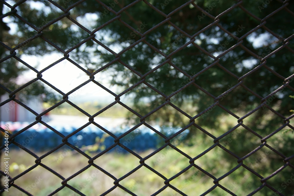 Closeup view of chain link fence with blurred background Closeup view of chain link fence with blurred background