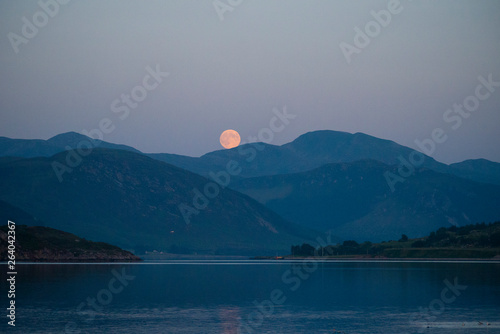 Strawberry moon rise over the An Tellach mountain range photo