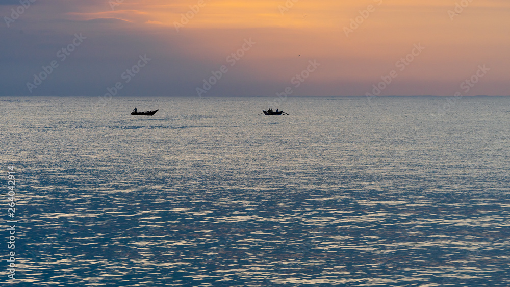 Two fishing boats at the open sea