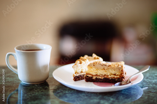 Cup of tea or coffee and cake slice  dessert on table