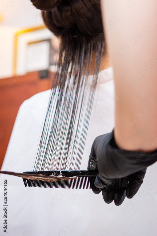 Fototapeta premium Zabieg keratynowy u fryzjera - Keratin treatment at the hairdresser
