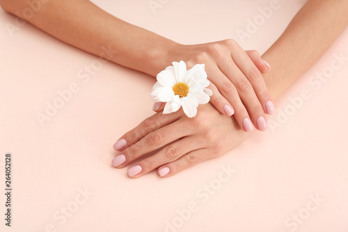 Closeup view of woman with flower on color background. Spa treatment