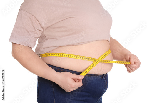 Overweight woman measuring waist with tape isolated on white, closeup