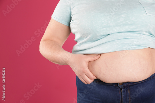 Overweight woman on color background, closeup. Space for text