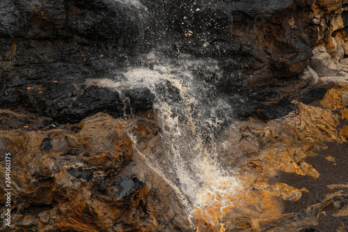 Beautiful view of a waterfall flowing between fantastic scultural rocks  in Turkey.  photo