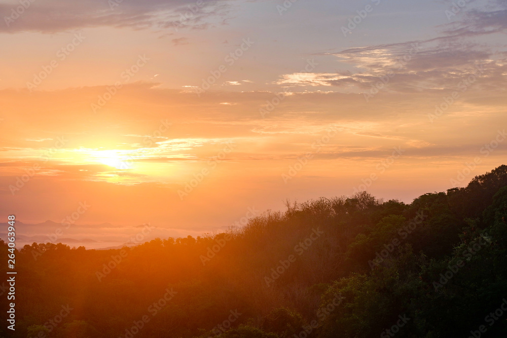 Beautiful landscape sunrise in the forest  view foggy hill covered mountains and sunlight through the clouds sky