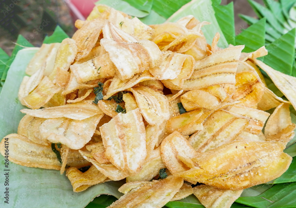Fried banana slice crispy with sugar on banana leaf background Fried banana slice crispy with sugar on banana leaf background