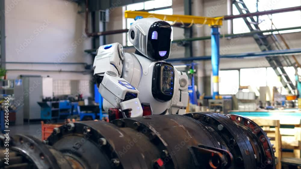 Droid is using a drill to process metal equipment Droid is using a drill to process metal equipment