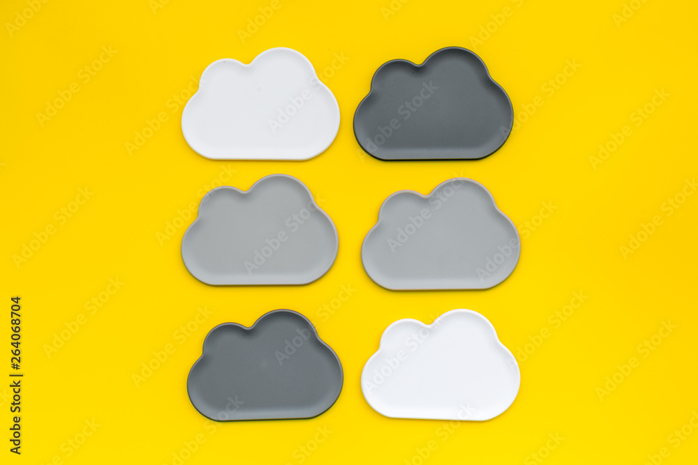 Obraz premium cloud service concept with clouds on yellow background top view