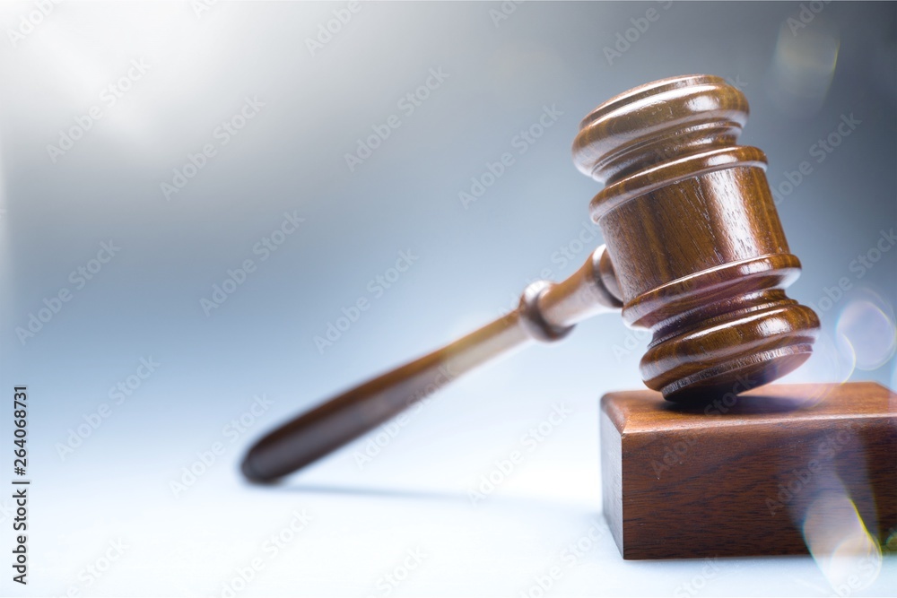 Wooden gavel on wooden table, on background Wooden gavel on wooden table, on background