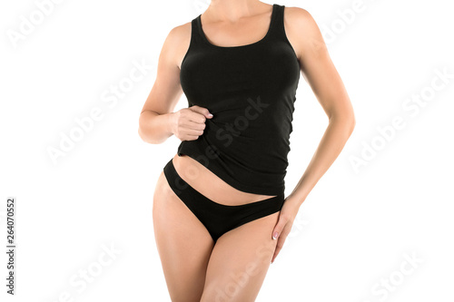 Sexy female cropped fit body in black panties and long top, isolated on white.