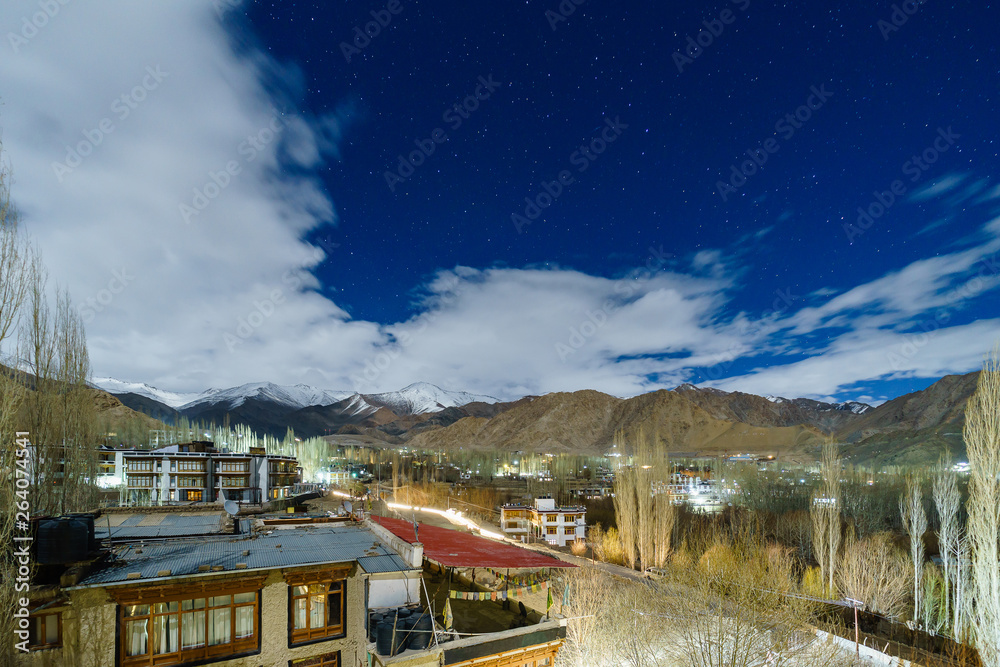 Landscape image of Leh city with mountains view and stars in the sky at night
