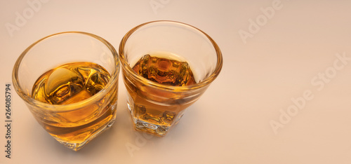 Whiskey glass with decorative lights on a white gradient background Celebration drinking concept Text entry area