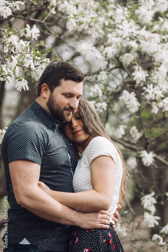 Young lovely couple walking in spring park 