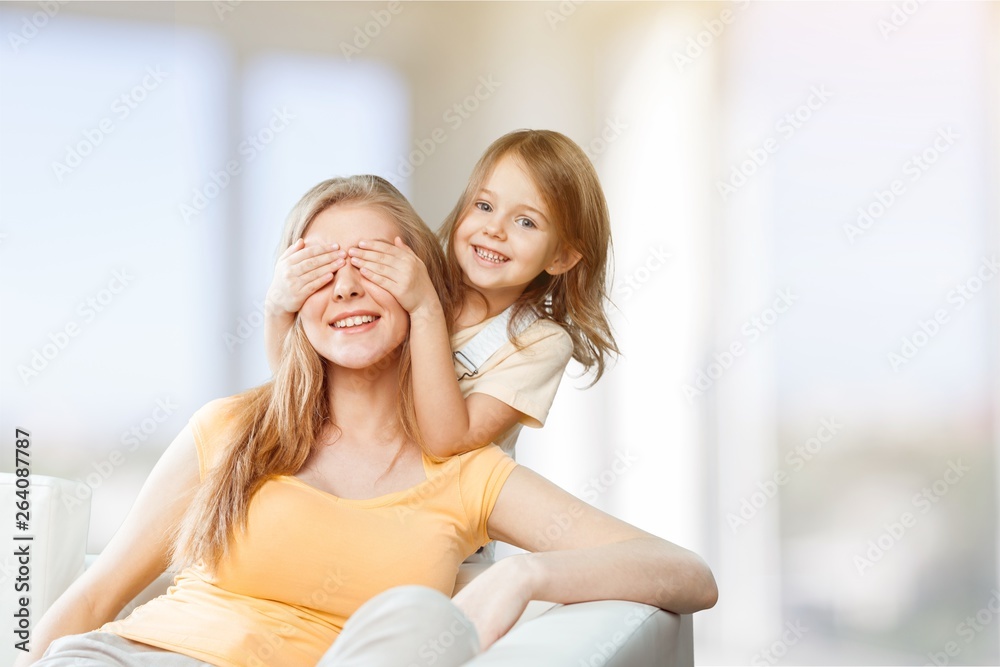 Portrait of happy mother and daughter holding flowers Portrait of happy mother and daughter holding flowers