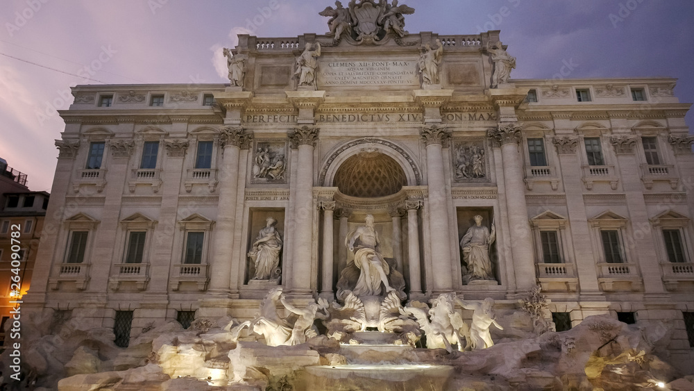 dusk wide angle shot of trevi fountain in rome