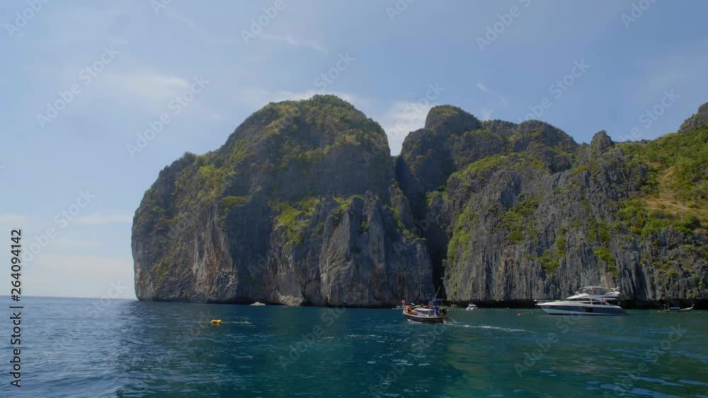 Boats along the edge of the Phi Phi Islands in Thailand Boats along the edge of the Phi Phi Islands in Thailand