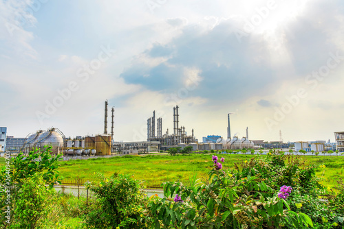 Oil refineries and storage tanks in the plant under the background of blue sky white clouds
