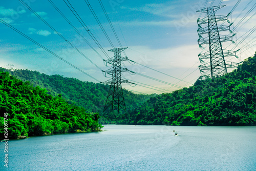 Cuadro en lienzo Electricity transmission line with green mountain on dam, Green conservative ene