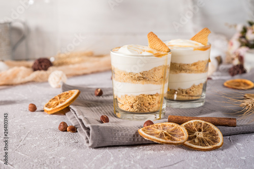 Layered mascarpone dessert with crushed vanilla biscuits and carame photo