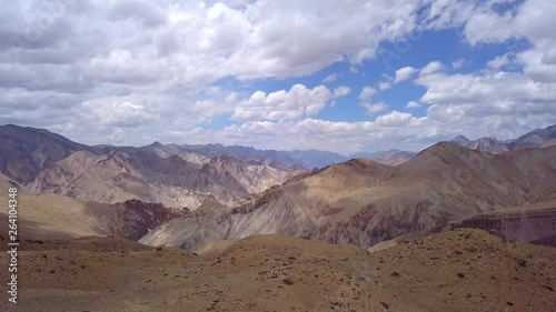 Dolly zoom of a high chain mountain range in the Himalayas as flying backward over a ridge photo